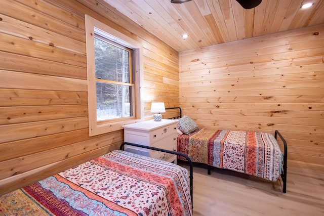 bedroom with wood ceiling and wood walls