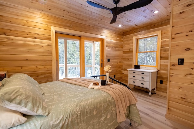 bedroom with wooden ceiling, wood walls, ceiling fan, and light wood-type flooring