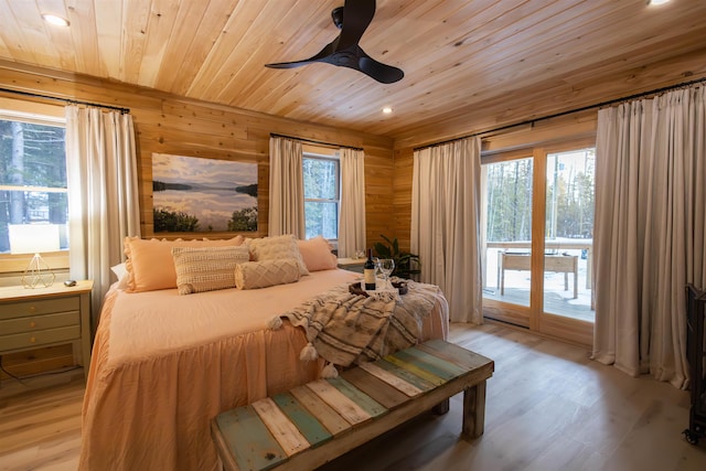 bedroom with wood ceiling, light hardwood / wood-style flooring, ceiling fan, access to exterior, and wooden walls