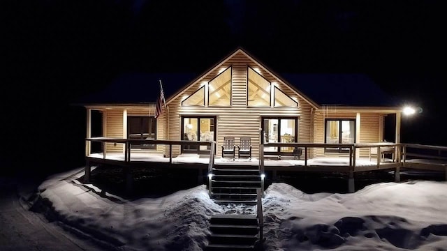 view of snow covered back of property