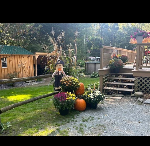 view of yard with a storage unit and a deck