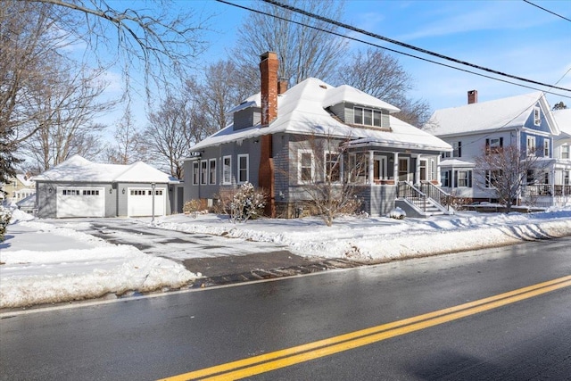 view of front of house with a garage, an outbuilding, and covered porch