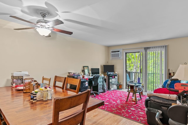 dining space with wood-type flooring, a wall mounted air conditioner, and ceiling fan