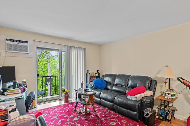 living room featuring hardwood / wood-style floors and a wall unit AC