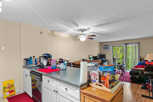 kitchen featuring sink, a wall mounted AC, dishwasher, hardwood / wood-style floors, and white cabinets