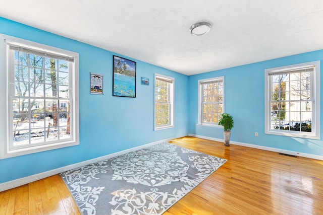 sitting room with hardwood / wood-style floors and a wealth of natural light