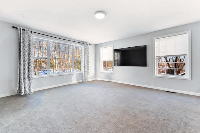 unfurnished living room featuring carpet floors