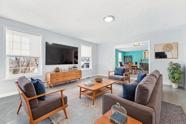 living room featuring concrete flooring