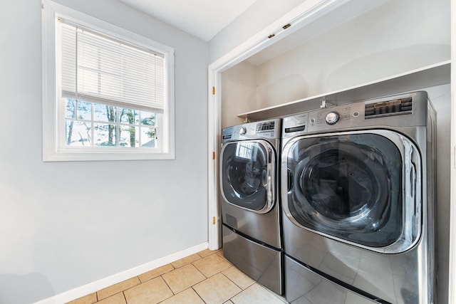 laundry room featuring light tile patterned floors and washing machine and clothes dryer