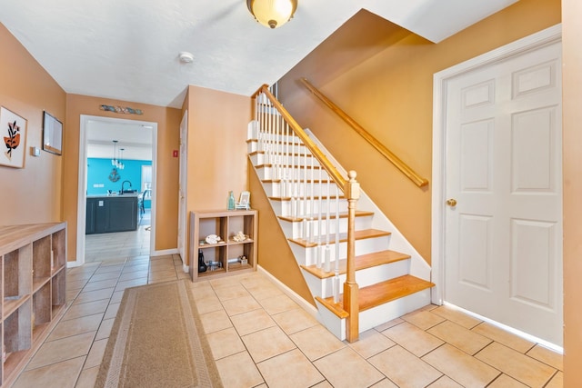 stairway with sink and tile patterned flooring