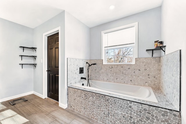 bathroom with tiled bath