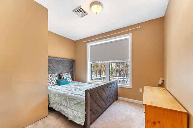 bedroom featuring light carpet