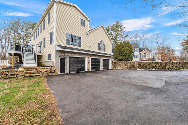 view of side of home with a garage and a deck