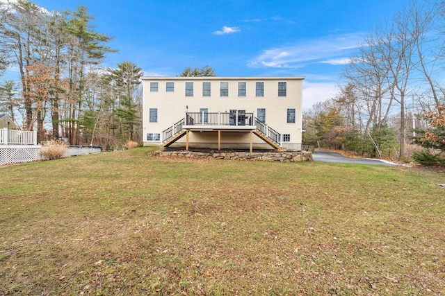 back of property with a yard and a deck