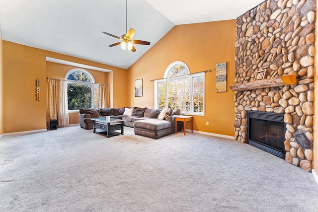 carpeted living room with a fireplace, plenty of natural light, high vaulted ceiling, and ceiling fan