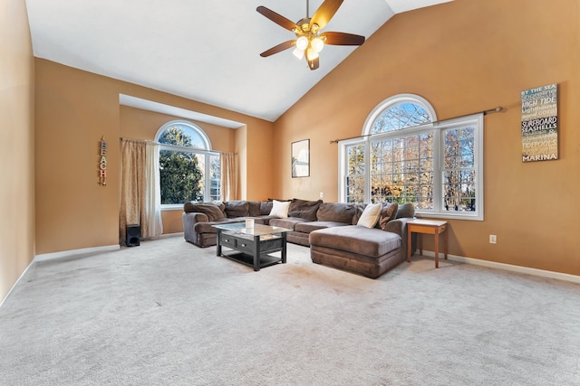 carpeted living room with ceiling fan and high vaulted ceiling