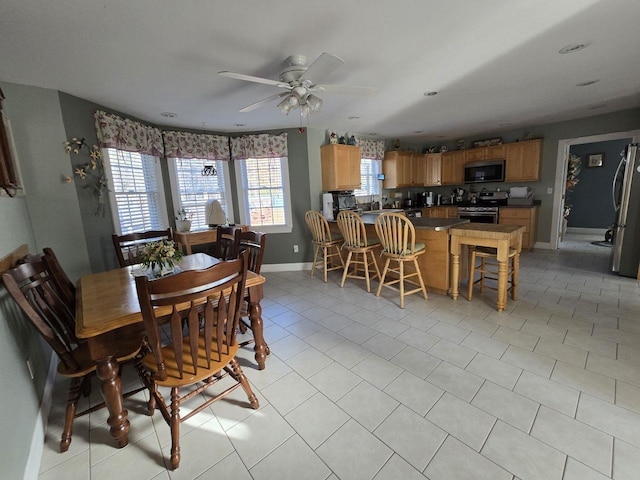 dining room with light tile patterned floors and ceiling fan