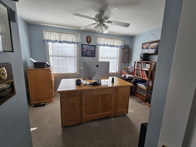 carpeted office space with a wealth of natural light and ceiling fan