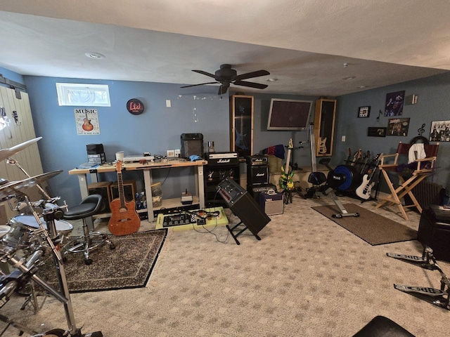 workout room featuring ceiling fan and carpet