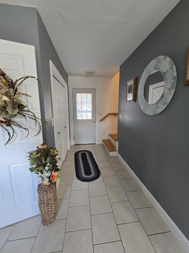 entryway with light tile patterned floors