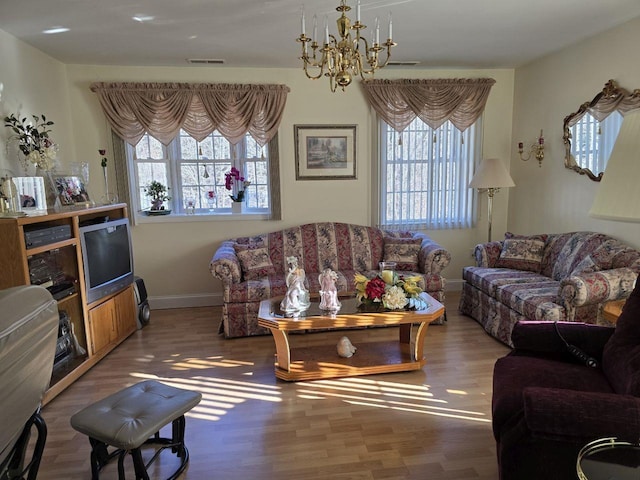 living room featuring hardwood / wood-style flooring and a notable chandelier