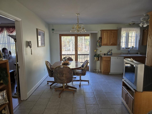 dining space featuring plenty of natural light, sink, and an inviting chandelier