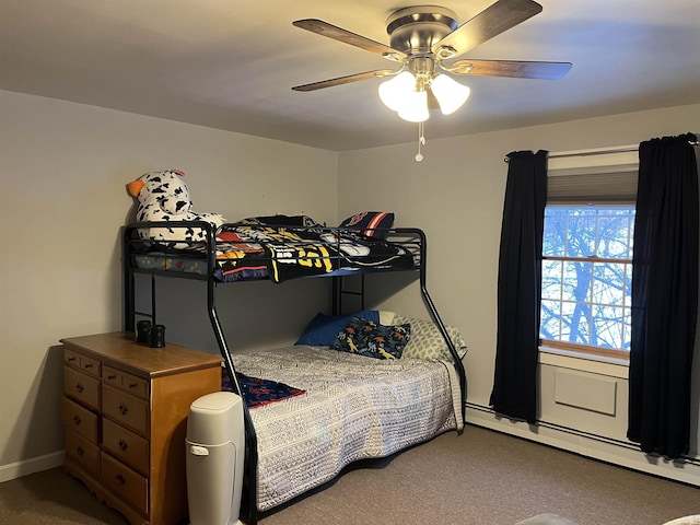 carpeted bedroom featuring a baseboard radiator and ceiling fan