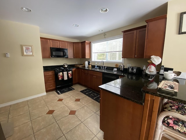 kitchen with sink, light tile patterned floors, dark stone countertops, kitchen peninsula, and black appliances