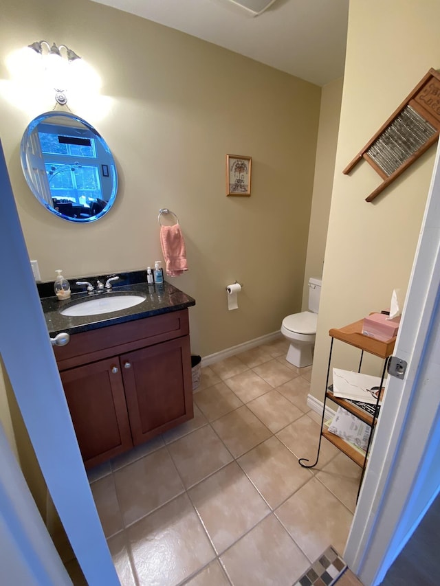 bathroom with vanity, toilet, and tile patterned flooring