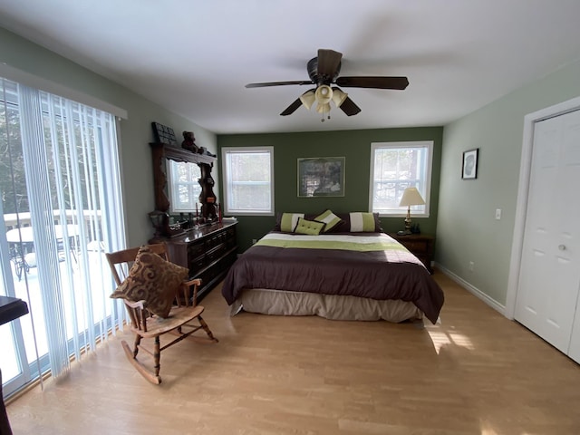 bedroom featuring light wood-type flooring, access to exterior, and ceiling fan