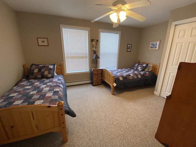 carpeted bedroom featuring ceiling fan and baseboard heating