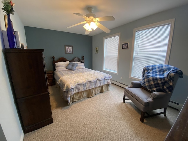 carpeted bedroom featuring a baseboard heating unit and ceiling fan