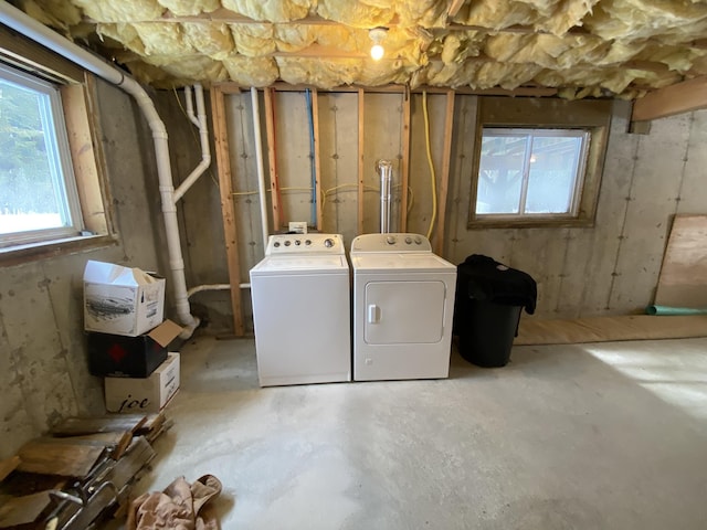 clothes washing area with washing machine and dryer