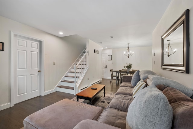 living room with a notable chandelier, dark hardwood / wood-style floors, and baseboard heating