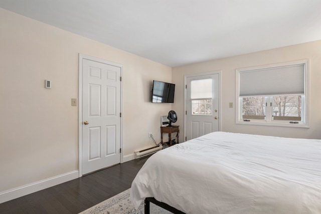 bedroom with dark hardwood / wood-style flooring and a baseboard radiator