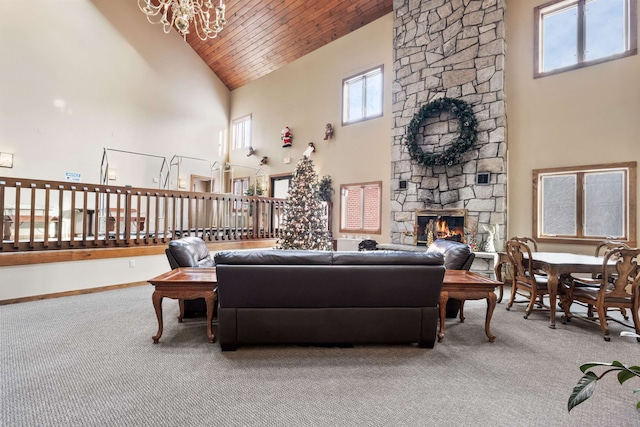 living room with wood ceiling, a fireplace, carpet flooring, and high vaulted ceiling