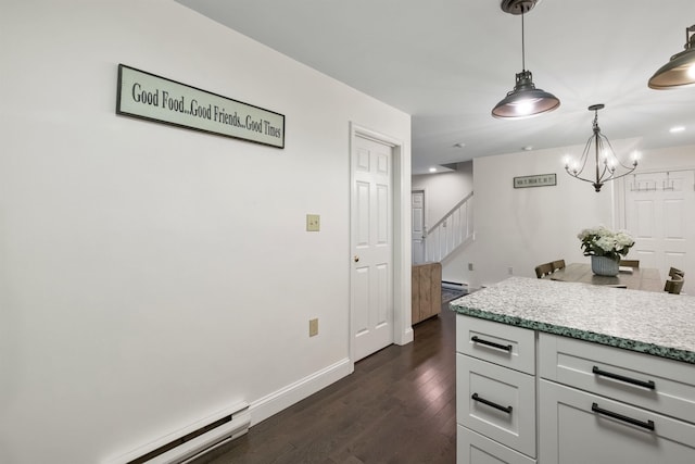 kitchen with pendant lighting, a baseboard radiator, dark hardwood / wood-style floors, and white cabinets