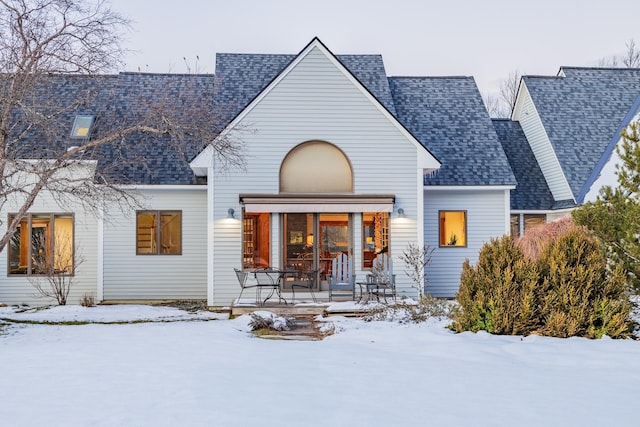 view of snow covered rear of property