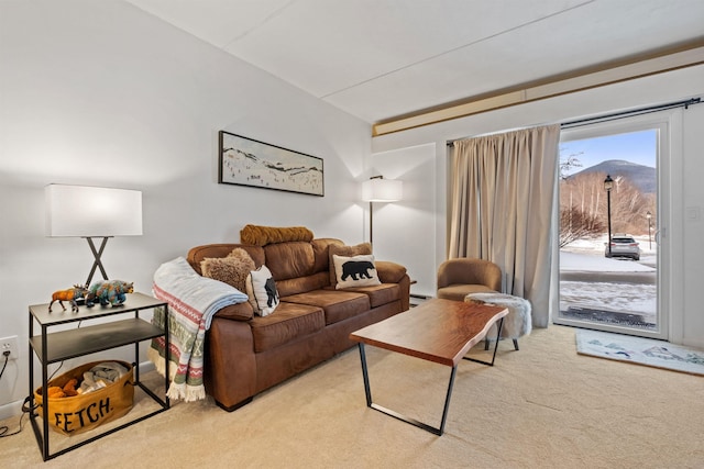 living room featuring a mountain view and light colored carpet