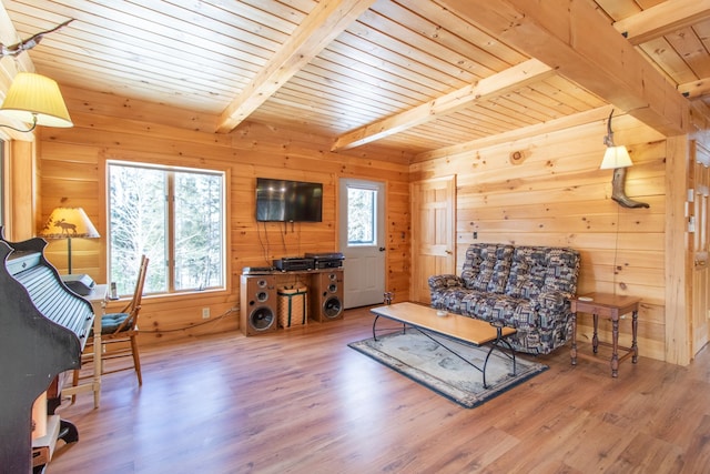 living room with beamed ceiling, wooden walls, hardwood / wood-style floors, and wooden ceiling