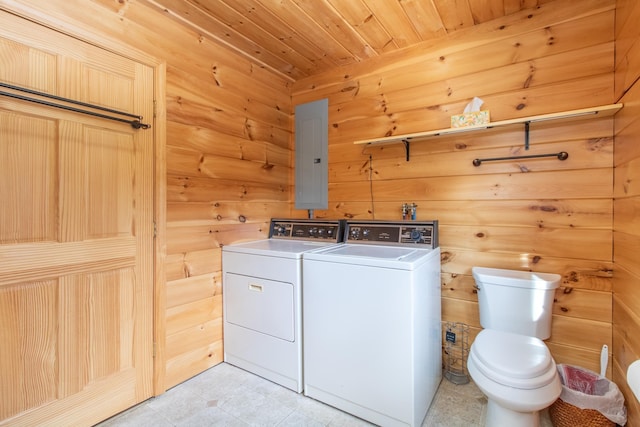 laundry room featuring washer and dryer, wooden walls, electric panel, and wood ceiling