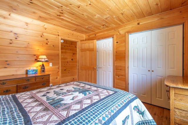 bedroom featuring wood ceiling and wood walls