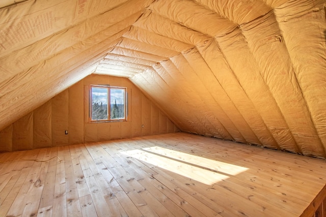 bonus room featuring wood-type flooring and vaulted ceiling