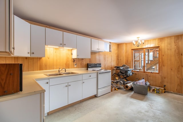 kitchen with sink, white electric range, white cabinets, and wood walls