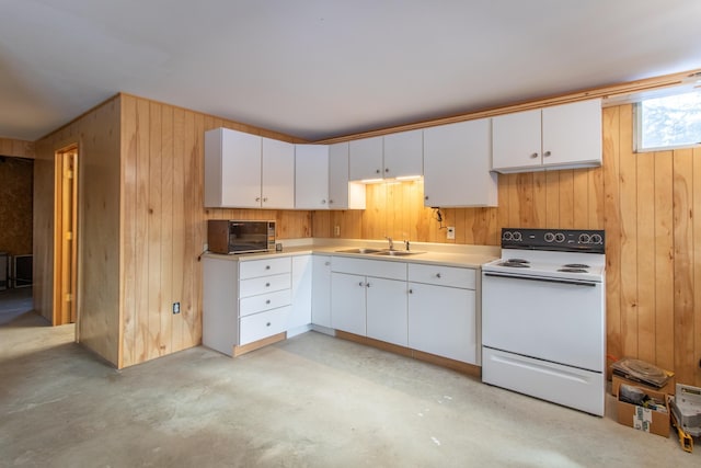 kitchen featuring white cabinetry, sink, electric range, and wooden walls