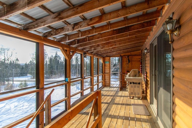 sunroom / solarium featuring vaulted ceiling