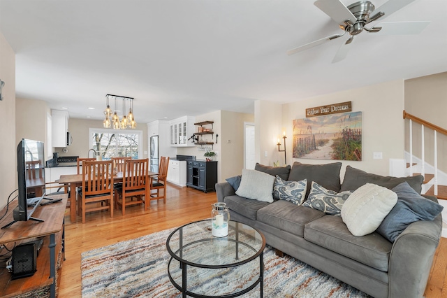 living room featuring light hardwood / wood-style flooring and ceiling fan