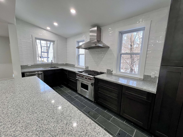 kitchen with sink, backsplash, stainless steel appliances, light stone counters, and extractor fan