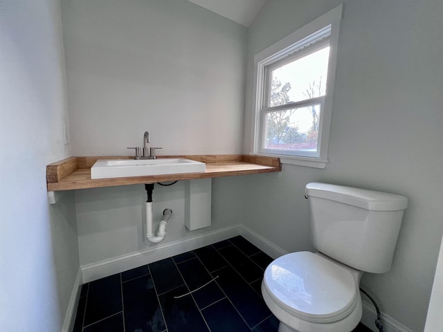 bathroom featuring vaulted ceiling, sink, and toilet