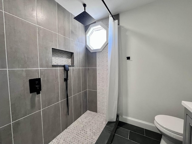 bathroom with toilet, vanity, tile patterned floors, and a shower with shower curtain